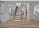 Open and airy staircase with hardwood treads and stylish black railings at 56 Linneys Mountain Rd, Taylorsville, NC 28681