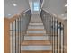 A staircase featuring wood and white stairs with black modern metal railings at 56 Linneys Mountain Rd, Taylorsville, NC 28681