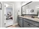 Bathroom with gray cabinets, granite countertop and a view into the bedroom at 618 Bannerman Ln, Fort Mill, SC 29715