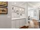Wet bar with white cabinets, quartz counters, and glass shelving near the dining room at 618 Bannerman Ln, Fort Mill, SC 29715