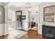 Elegant foyer featuring hardwood floors, a decorative chandelier, and a glimpse into the office at 618 Bannerman Ln, Fort Mill, SC 29715