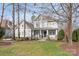 Charming two-story home featuring a welcoming front porch, manicured lawn, and classic architectural details at 618 Bannerman Ln, Fort Mill, SC 29715