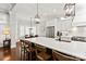 Eat-in kitchen boasts white cabinetry, a large island with seating, and hardwood flooring at 618 Bannerman Ln, Fort Mill, SC 29715