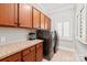 Well-organized laundry room with built-in cabinets, counter space, and modern washer and dryer at 618 Bannerman Ln, Fort Mill, SC 29715