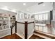 Open living room with wood floors, white trim, large windows, and custom built-in shelving at 618 Bannerman Ln, Fort Mill, SC 29715