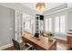 Stylish office space features a wooden desk, hardwood flooring, and glass french doors at 618 Bannerman Ln, Fort Mill, SC 29715
