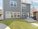 Back exterior featuring large windows and a pergola at 6332 Kennard Dr, Charlotte, NC 28216