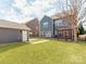 Large backyard with lush green grass and a pergola at 6332 Kennard Dr, Charlotte, NC 28216