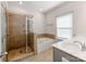 Bright bathroom featuring a glass-enclosed shower, soaking tub, and a double sink vanity with stylish fixtures at 6332 Kennard Dr, Charlotte, NC 28216