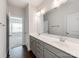 Bright bathroom featuring a double sink vanity, gray cabinets, and a large mirror at 6332 Kennard Dr, Charlotte, NC 28216