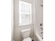 Bright bathroom featuring a white toilet next to a tub with a shower at 6332 Kennard Dr, Charlotte, NC 28216