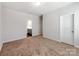 Neutral bedroom with plush carpeting, ample natural light, and connecting doors to other rooms at 6332 Kennard Dr, Charlotte, NC 28216