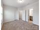 Spacious bedroom with neutral carpeting and three doors at 6332 Kennard Dr, Charlotte, NC 28216