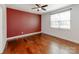 Spacious bedroom with hardwood floors, ceiling fan, and bright natural light from a large window at 6332 Kennard Dr, Charlotte, NC 28216