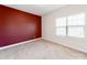 Neutral bedroom with a red accent wall and a large bright window at 6332 Kennard Dr, Charlotte, NC 28216
