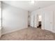 Spacious bedroom features neutral carpeting, ample natural light, and doorways to an en-suite bathroom at 6332 Kennard Dr, Charlotte, NC 28216