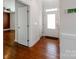 Bright foyer featuring a white door, hardwood floors, and neutral wall paint at 6332 Kennard Dr, Charlotte, NC 28216