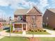 Charming two-story brick home with a welcoming porch and landscaped front yard at 6332 Kennard Dr, Charlotte, NC 28216
