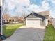 Detached two car garage with a driveway and grassy yard at 6332 Kennard Dr, Charlotte, NC 28216