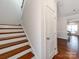 A bright hallway with wooden floors leading to an open-concept living area and stairway at 6332 Kennard Dr, Charlotte, NC 28216