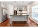 Charming kitchen with stainless steel appliances, island with granite countertop, and modern cabinetry at 6332 Kennard Dr, Charlotte, NC 28216