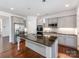 Modern kitchen features stainless steel refrigerator, granite countertops, and gray cabinets at 6332 Kennard Dr, Charlotte, NC 28216