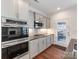 Modern kitchen featuring stainless steel appliances, granite countertops, and tile backsplash at 6332 Kennard Dr, Charlotte, NC 28216