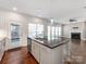 Kitchen area with granite island, stainless steel dishwasher, with open view to living room and fireplace at 6332 Kennard Dr, Charlotte, NC 28216