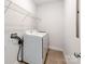 Laundry room featuring a white side-by-side washer and dryer and wire shelving at 6332 Kennard Dr, Charlotte, NC 28216