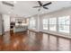 Bright living room features wood floors, ceiling fan, and large windows allowing ample natural light at 6332 Kennard Dr, Charlotte, NC 28216
