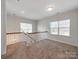 Bright loft area with plush carpeting, natural light from two windows, and white railing at 6332 Kennard Dr, Charlotte, NC 28216