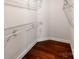 A simple walk-in closet featuring dark wood floors and white wire shelving at 6332 Kennard Dr, Charlotte, NC 28216
