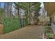 Gravel backyard with privacy fence, modern landscaping, and mature trees at 6366 Sharon Hills Rd, Charlotte, NC 28210