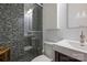 Modern bathroom with pebble stone shower floor and elegant white and black tiles at 6366 Sharon Hills Rd, Charlotte, NC 28210