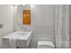 Modern bathroom with a ceramic tile backsplash, sleek fixtures, and a stylish sink at 6366 Sharon Hills Rd, Charlotte, NC 28210