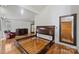 A bedroom with gleaming hardwood floors and a large mirror near a walk-in closet at 6366 Sharon Hills Rd, Charlotte, NC 28210