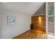 Bright bedroom with hardwood floors, wood paneling, and a large window at 6366 Sharon Hills Rd, Charlotte, NC 28210