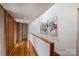 Hallway with wood accents, artwork, and access to various rooms at 6366 Sharon Hills Rd, Charlotte, NC 28210