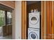 Convenient laundry closet with a stacked washer and dryer unit at 6366 Sharon Hills Rd, Charlotte, NC 28210