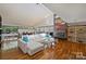 Bright living room with a fireplace, large windows, and hardwood floors at 6366 Sharon Hills Rd, Charlotte, NC 28210