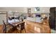 Open-concept living room with hardwood floors, opening to outdoor deck at 6366 Sharon Hills Rd, Charlotte, NC 28210