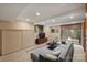 Finished basement featuring a large sofa, television, and sliding glass doors at 6366 Sharon Hills Rd, Charlotte, NC 28210