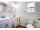 Modern bathroom featuring double sink vanity, toilet and a window with natural light at 66 Reed Ne St, Concord, NC 28025
