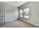 Bedroom with carpet, ceiling fan, and windows overlooking neighborhood at 66 Reed Ne St, Concord, NC 28025