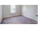 A bedroom with carpet, a window, and a door at 66 Reed Ne St, Concord, NC 28025