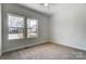 Bedroom with carpet, ceiling fan, and windows overlooking neighborhood at 66 Reed Ne St, Concord, NC 28025