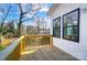 New wooden deck overlooking wooded area with black trimmed windows on home at 66 Reed Ne St, Concord, NC 28025