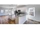 Modern kitchen with stainless appliances, an island, granite countertops, and white shaker cabinets at 66 Reed Ne St, Concord, NC 28025