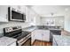 Bright kitchen featuring stainless steel appliances, granite countertops, and sleek cabinetry at 66 Reed Ne St, Concord, NC 28025