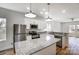 Modern kitchen with stainless steel appliances, granite countertops, island, and white cabinets at 66 Reed Ne St, Concord, NC 28025